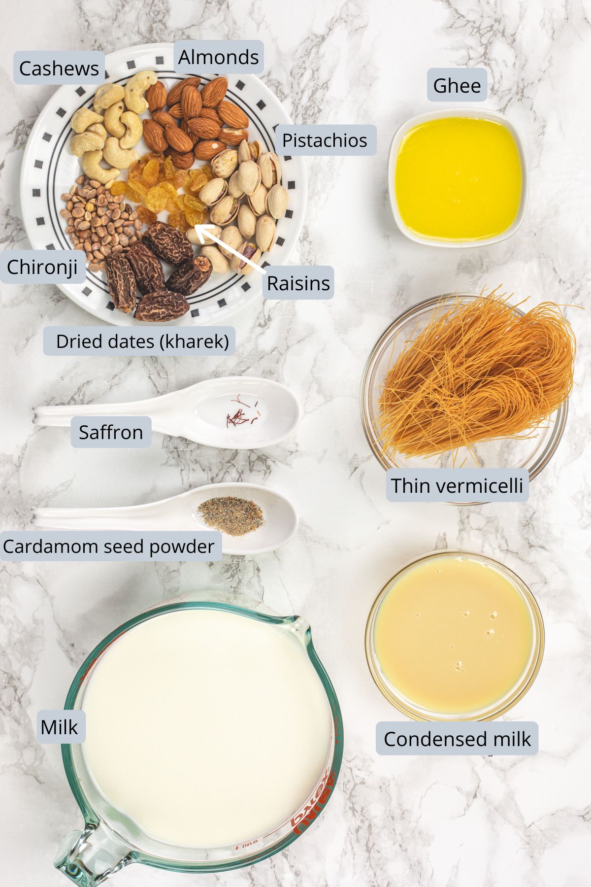 Sheer khurma ingredients in bowls, spoons and a plate with labels.