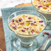 Sheer kurma served in glass bowl with spoons on the side.