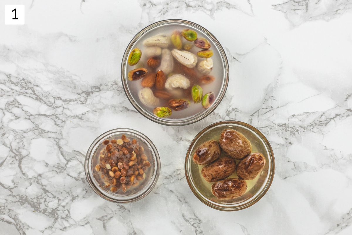 3 bowls with soaked nuts, raisins and dates.