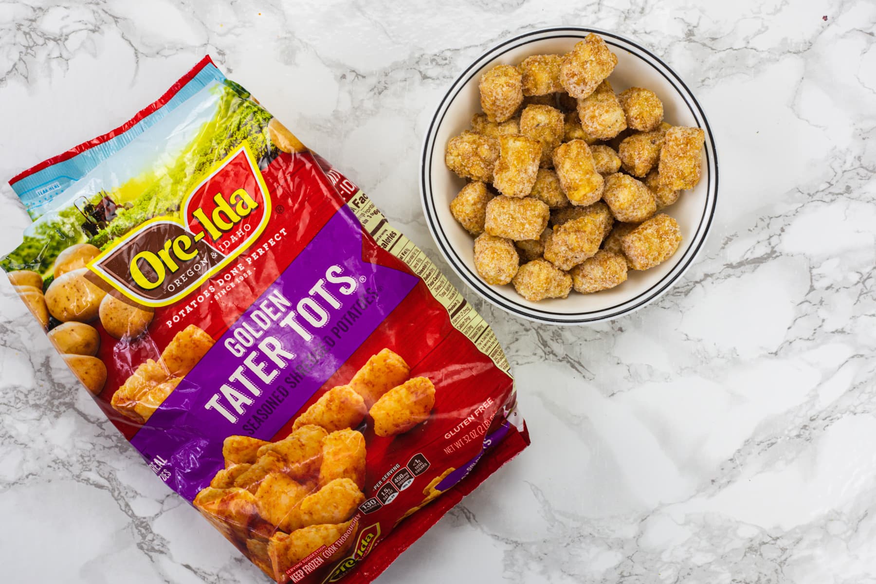 A pack of Ore-Ida tater tots and some in a bowl.