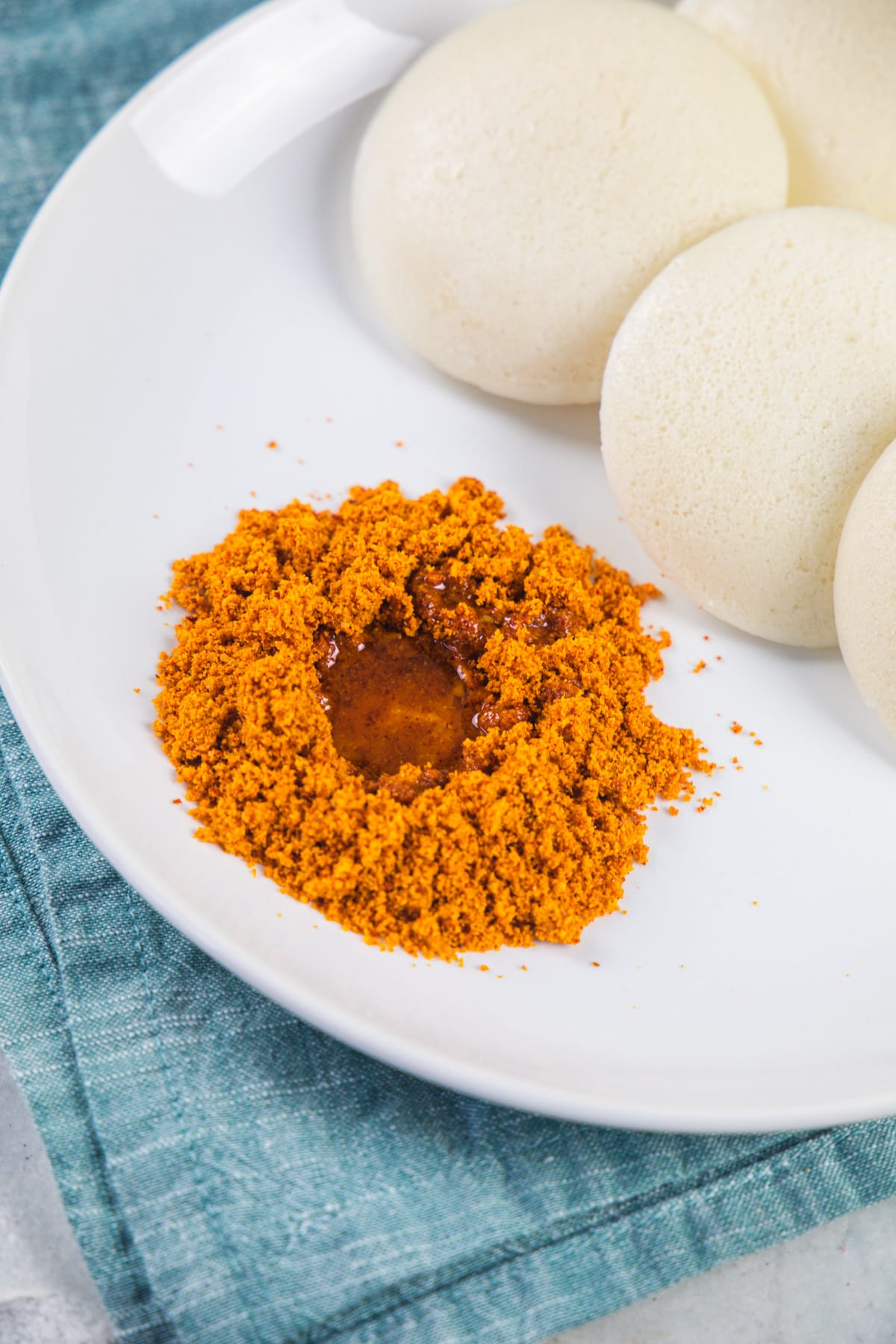 Idli podi with a drizzle of sesame oil with idli.