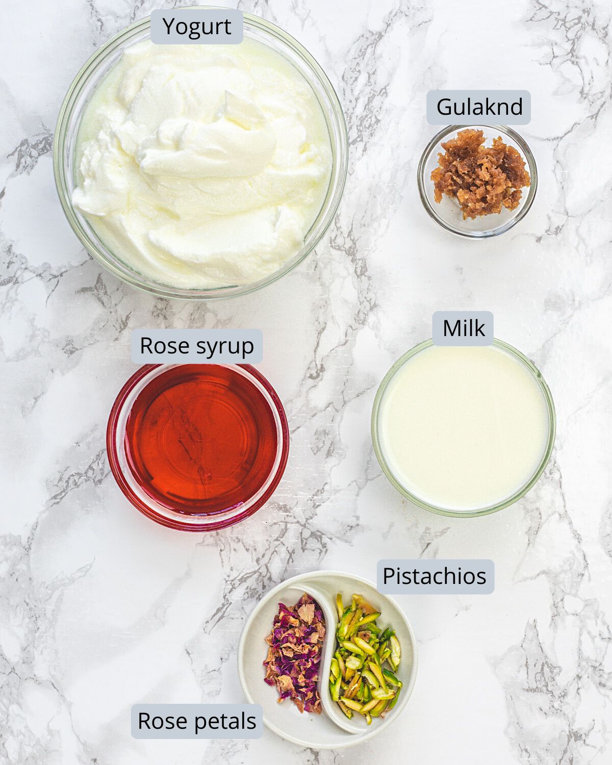 Rose lassi ingredients in bowls with labels.