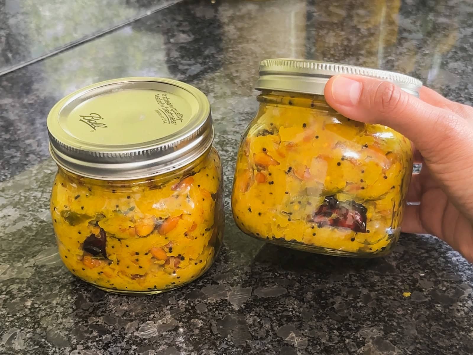 2 glass containers with raw mango rice premix.