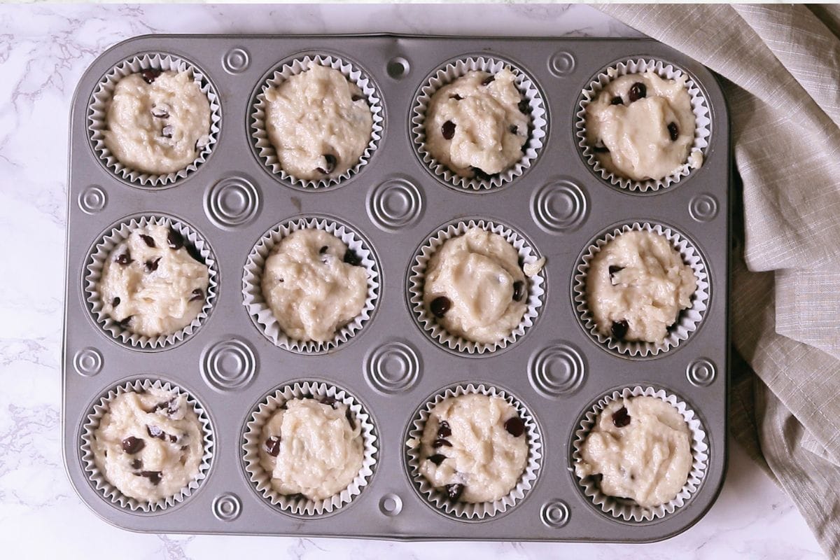 Eggless chocolate chip muffin batter in the muffin pan.