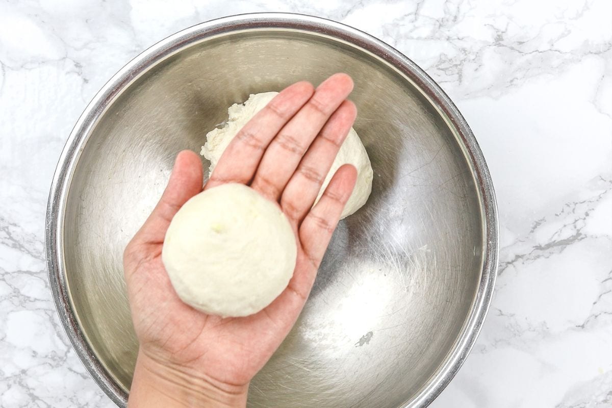 A small dough ball in a palm.