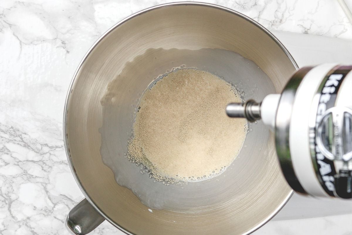 Adding yeast in a warm milk in kitchenaid bowl.