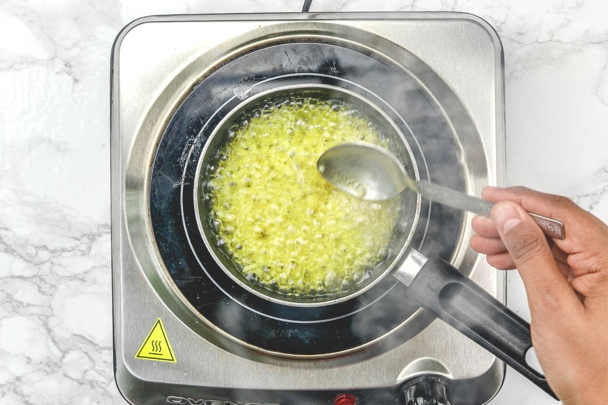 Sauteing garlic in ghee.
