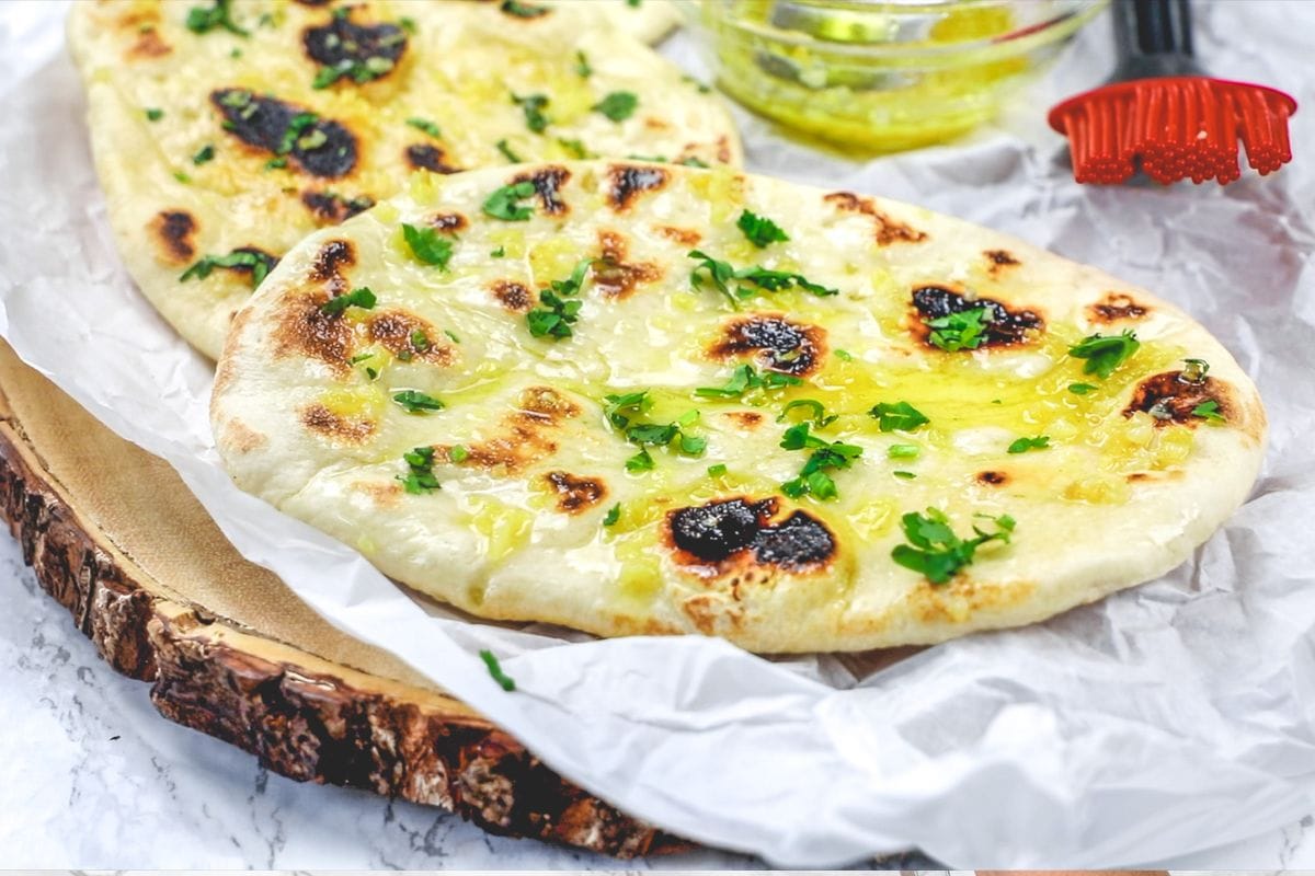 Garlic naan garnished with cilantro.