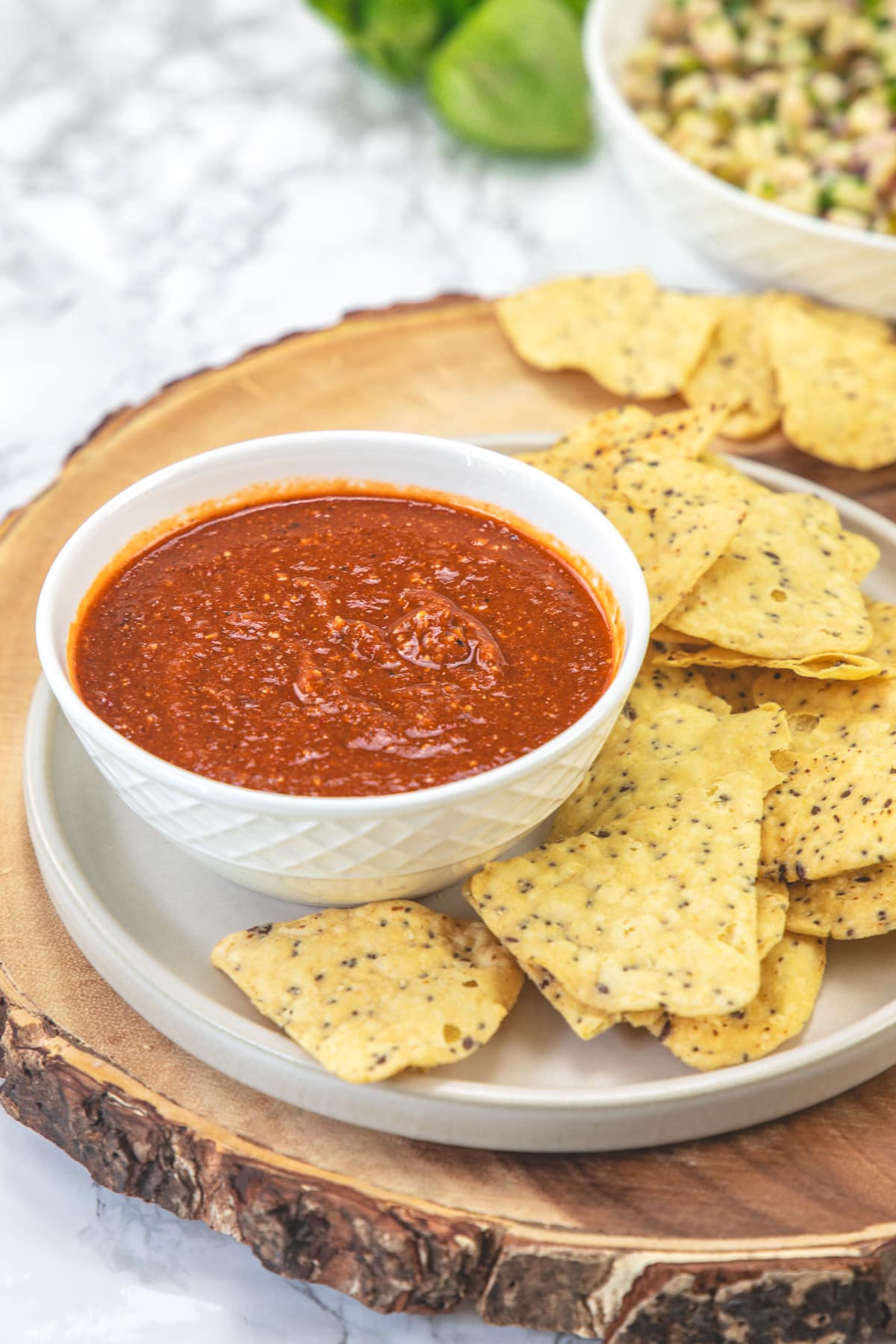 Chipotle hot salsa served in a bowl with chips on the side.