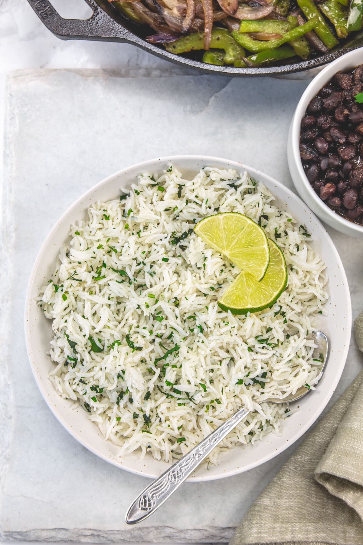 Chipotle cilantro lime rice in a bowl garnished with lime slices.