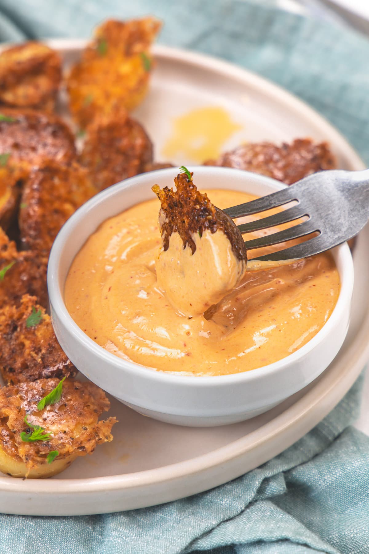 Dipping a potato piece into the chipotle mayo.