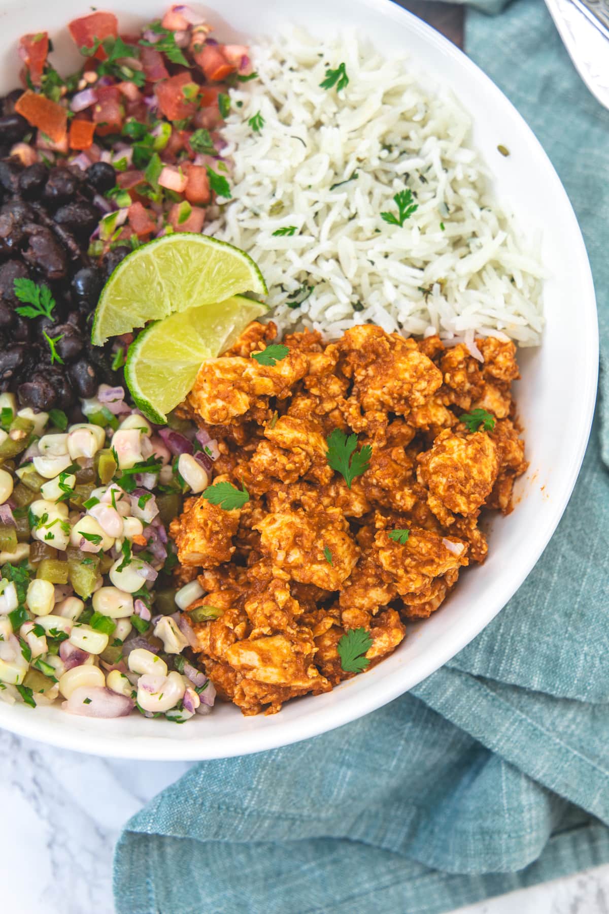 Chipotle sofritas served as a burrito bowl with rice, salsa, black beans and corn salsa.