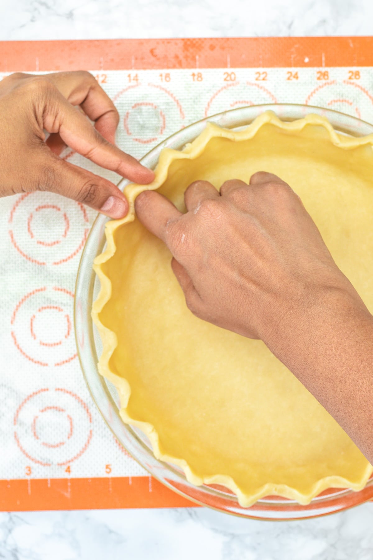 Shaping the edges of the food processor pie crust.