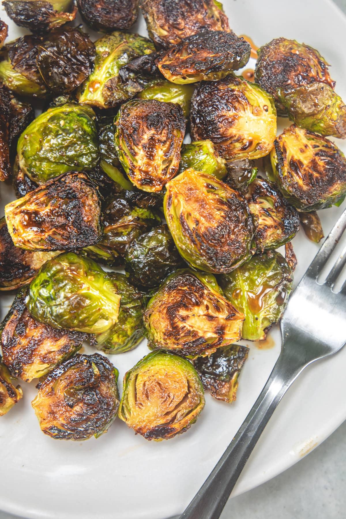 Balsamic Roasted Brussels Sprouts in a plate with fork.