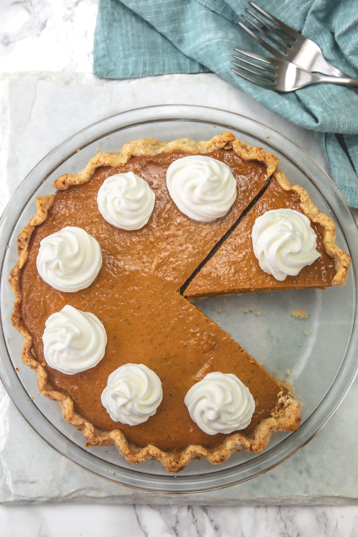 Once slice of eggless pumpkin pie is taken from a pie plate.