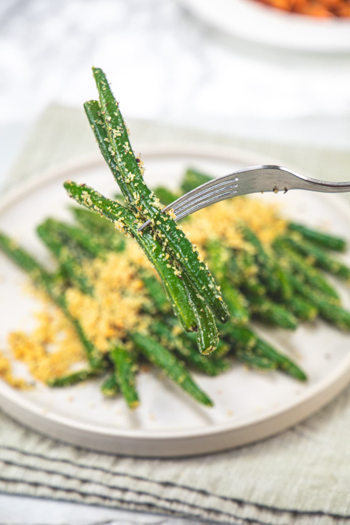 Taking a few Italian green beans in a fork.