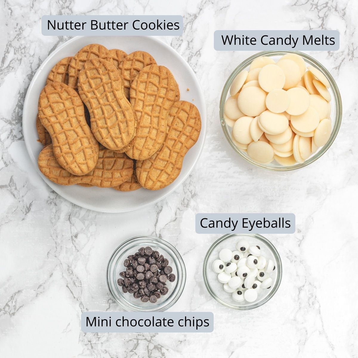 Nutter butter ghost cookies ingredients in bowls with labels.
