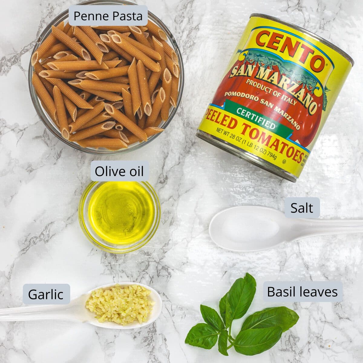 Penne Pomodoro ingredients in bowls and spoon with labels.