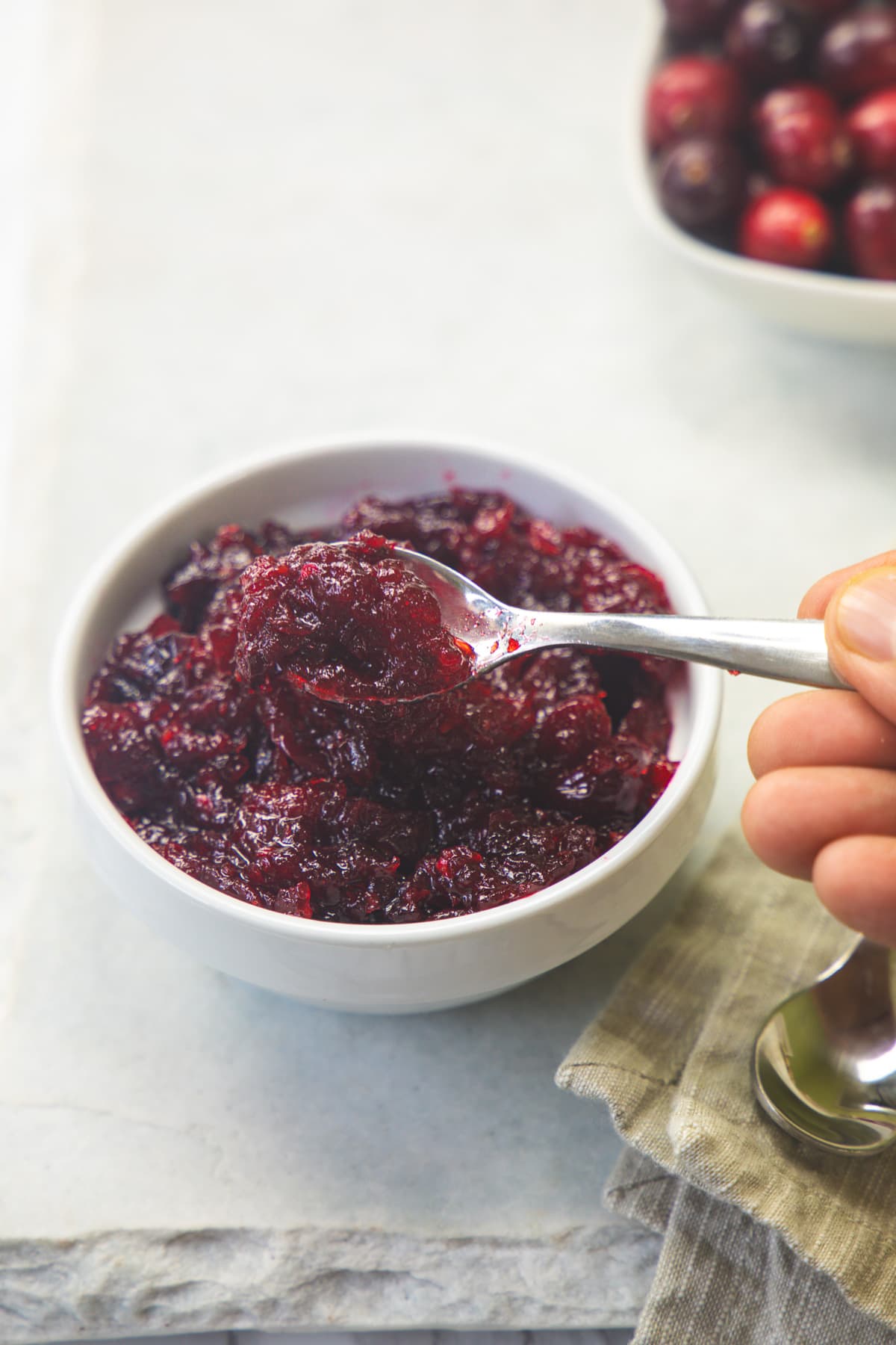 Taking a spoonful of cranberry chutney from the bowl.