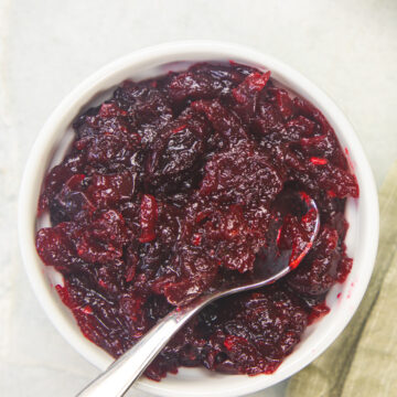 Cranberry chutney in a bowl with a small spoon in the bowl.