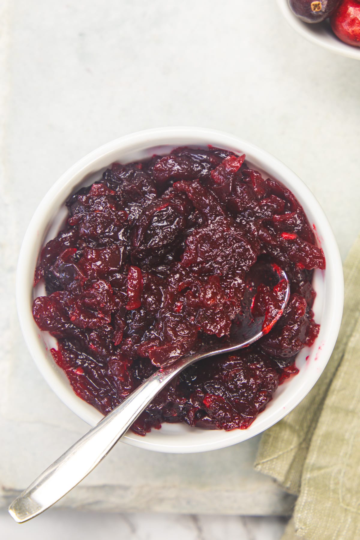 Cranberry chutney in a bowl with a small spoon in the bowl.