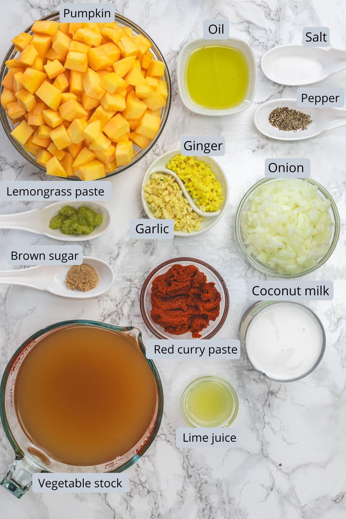 Thai curried pumpkin soup ingredients in bowls and spoons with labels.