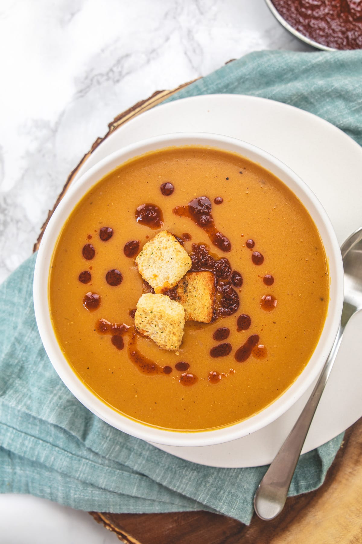 Turkish lentil soup served in a bowl with spoon on the side.