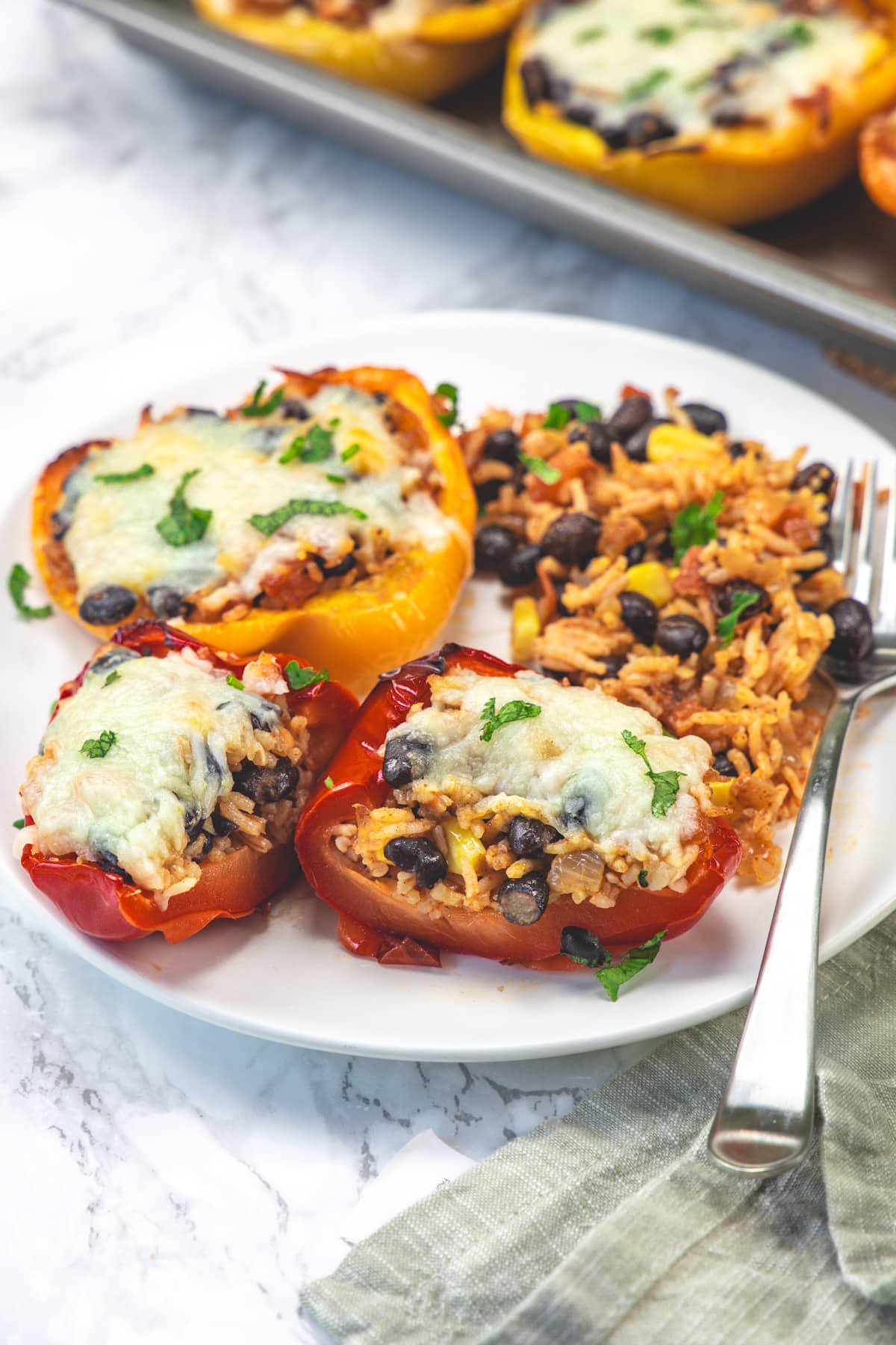 Cut open the vegetarian stuffed pepper garnished with cilantro.