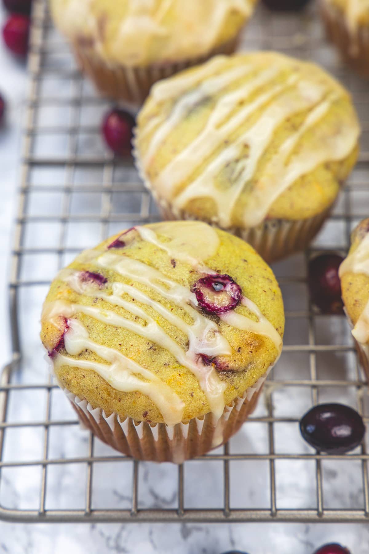 Eggless cranberry orange muffins on a wire rack.