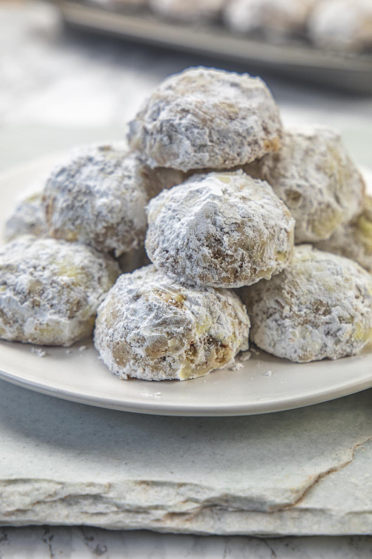 Pecan snowball cookies in a white plate.