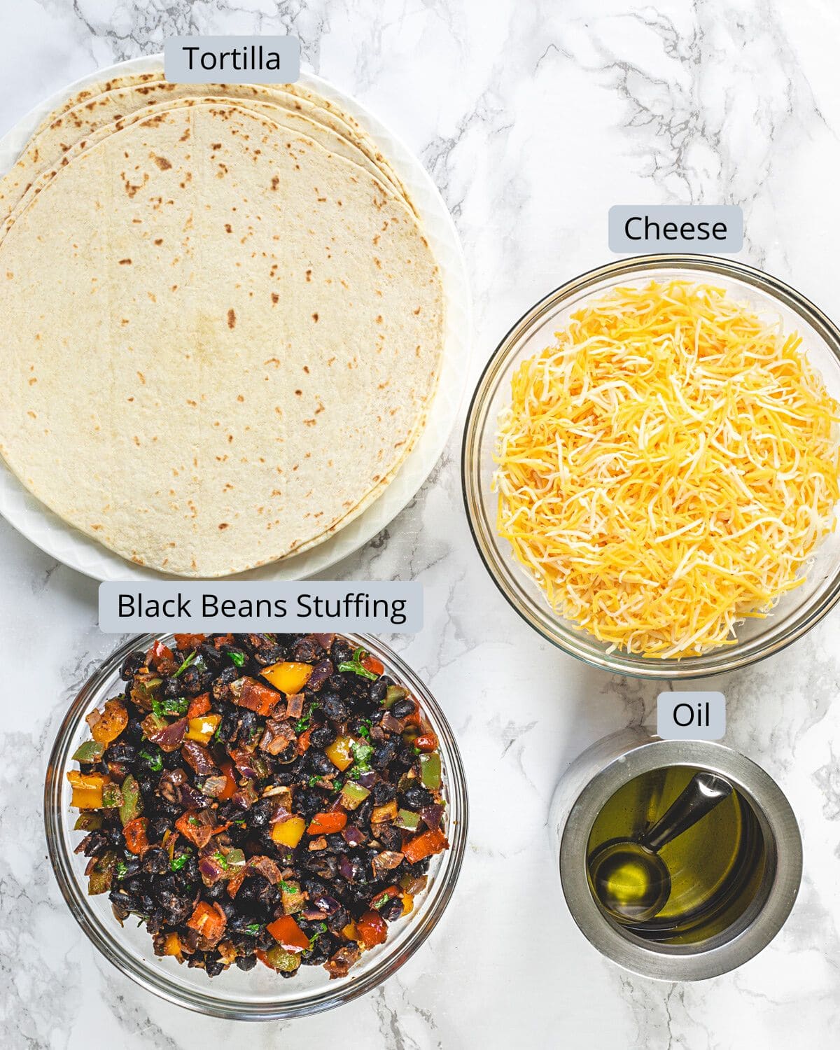 Black bean quesadilla stuffing and cheese in bowls with oil and tortillas with labels.