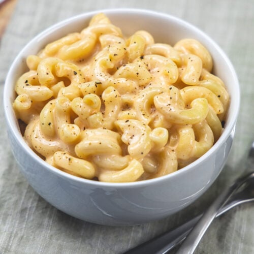 A bowl of cottage cheese mac and cheese with forks on the side.