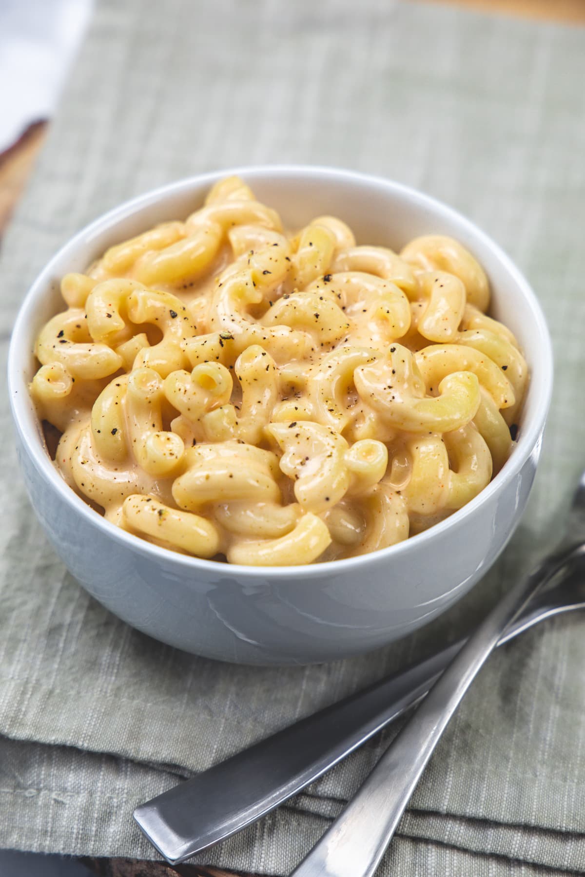 A bowl of cottage cheese mac and cheese with forks on the side.