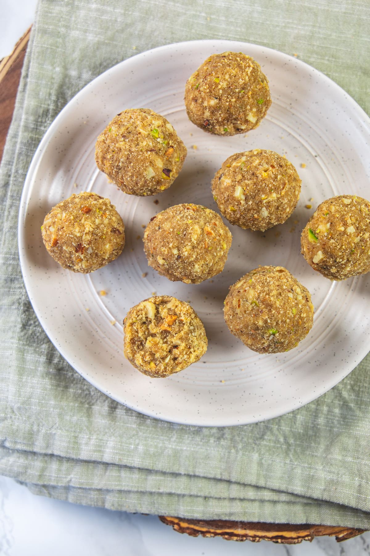 Once bite taken from gond ke laddu and rest are whole in a plate.