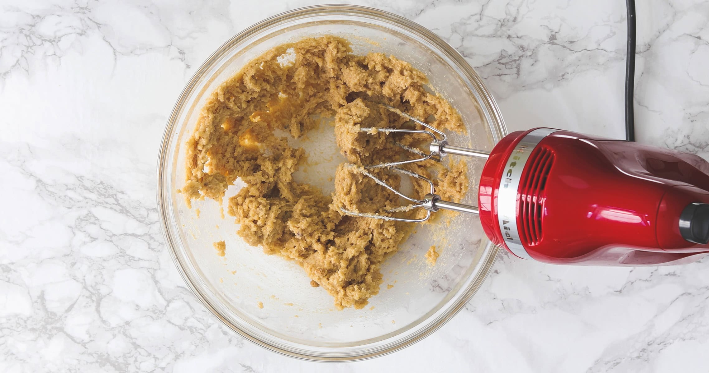 Creaming butter and sugar using hand mixer.