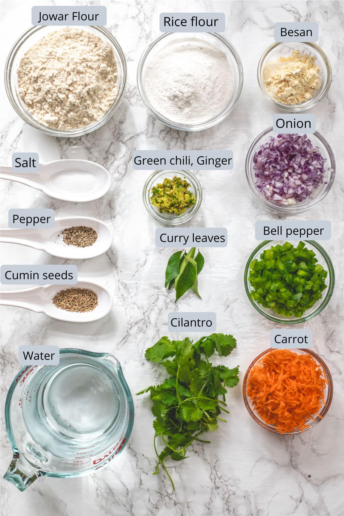 Jowar dosa ingredients in bowls and spoons with labels.