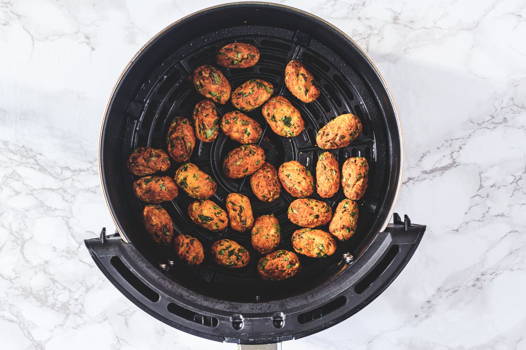 Methi muthia in air fryer basket.
