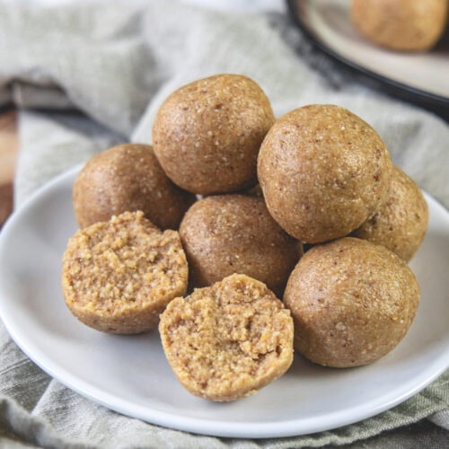 One peanut ladoo break in half with rest served in a plate.