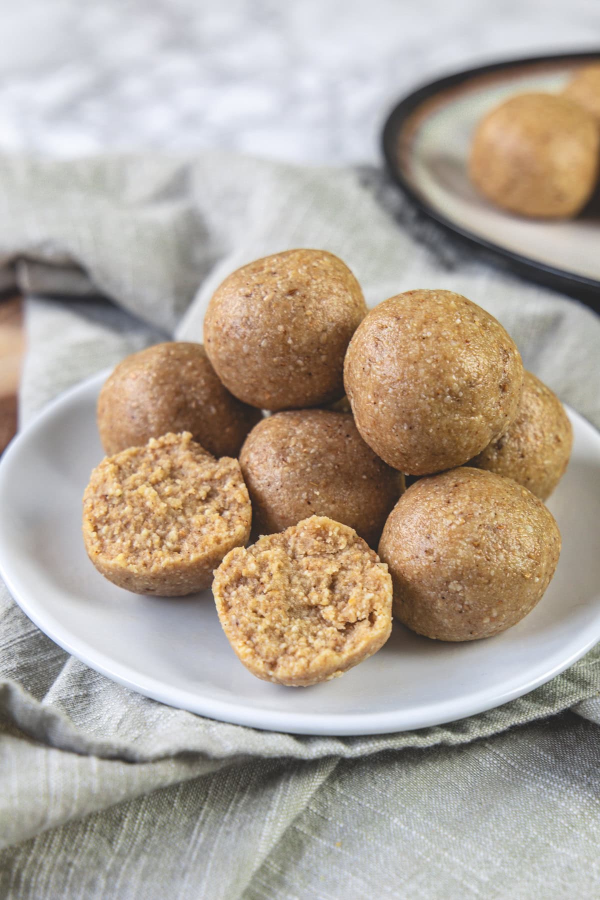 One peanut ladoo break in half with rest served in a plate.