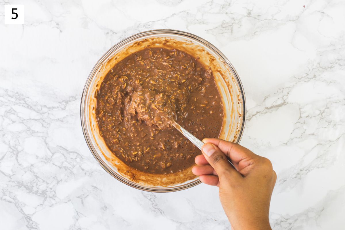 Showing a spoonful of chocolate overnight oats from the bowl after chilling.