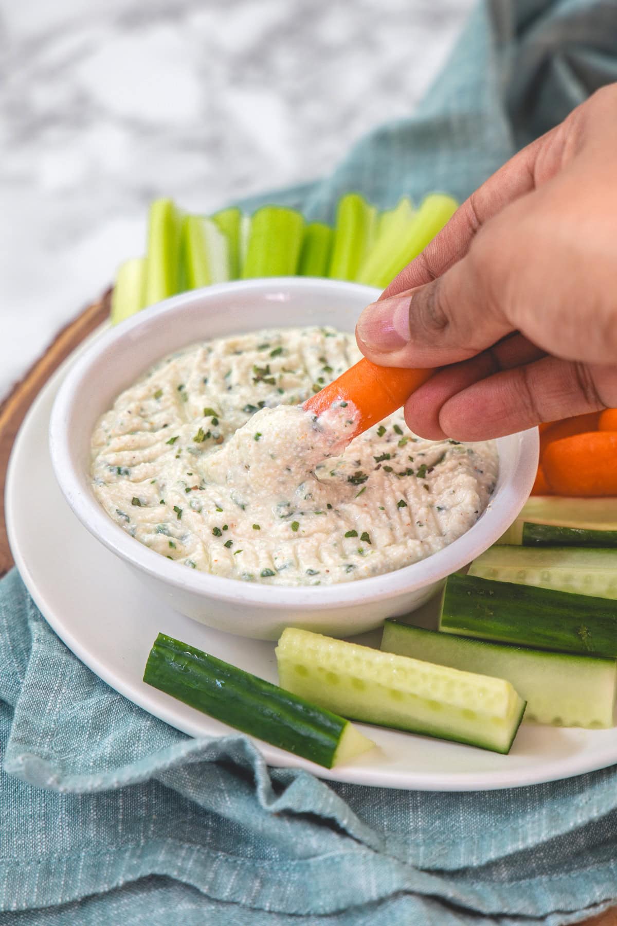 Dipping carrot into cottage cheese dip to show texture.