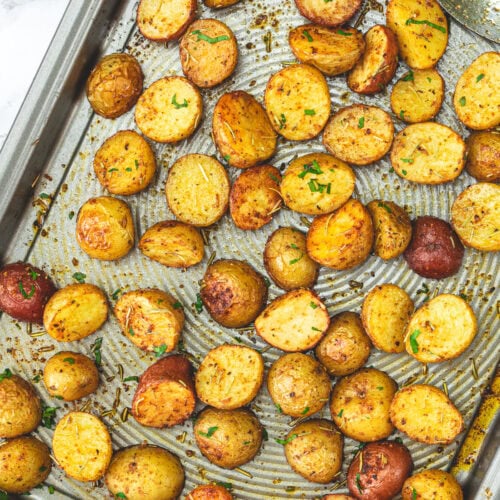 Roasted baby potatoes in a baking tray.
