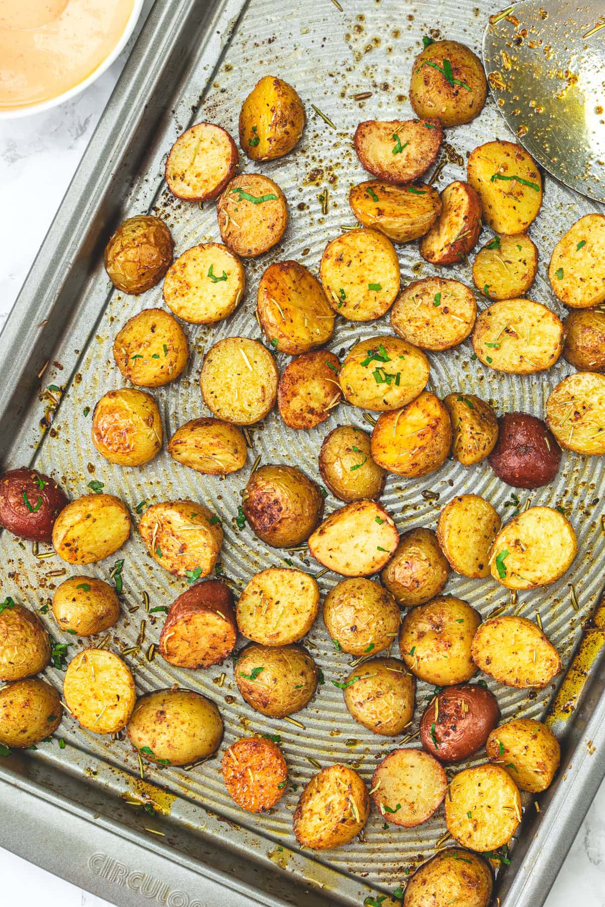 Roasted baby potatoes in a baking tray.