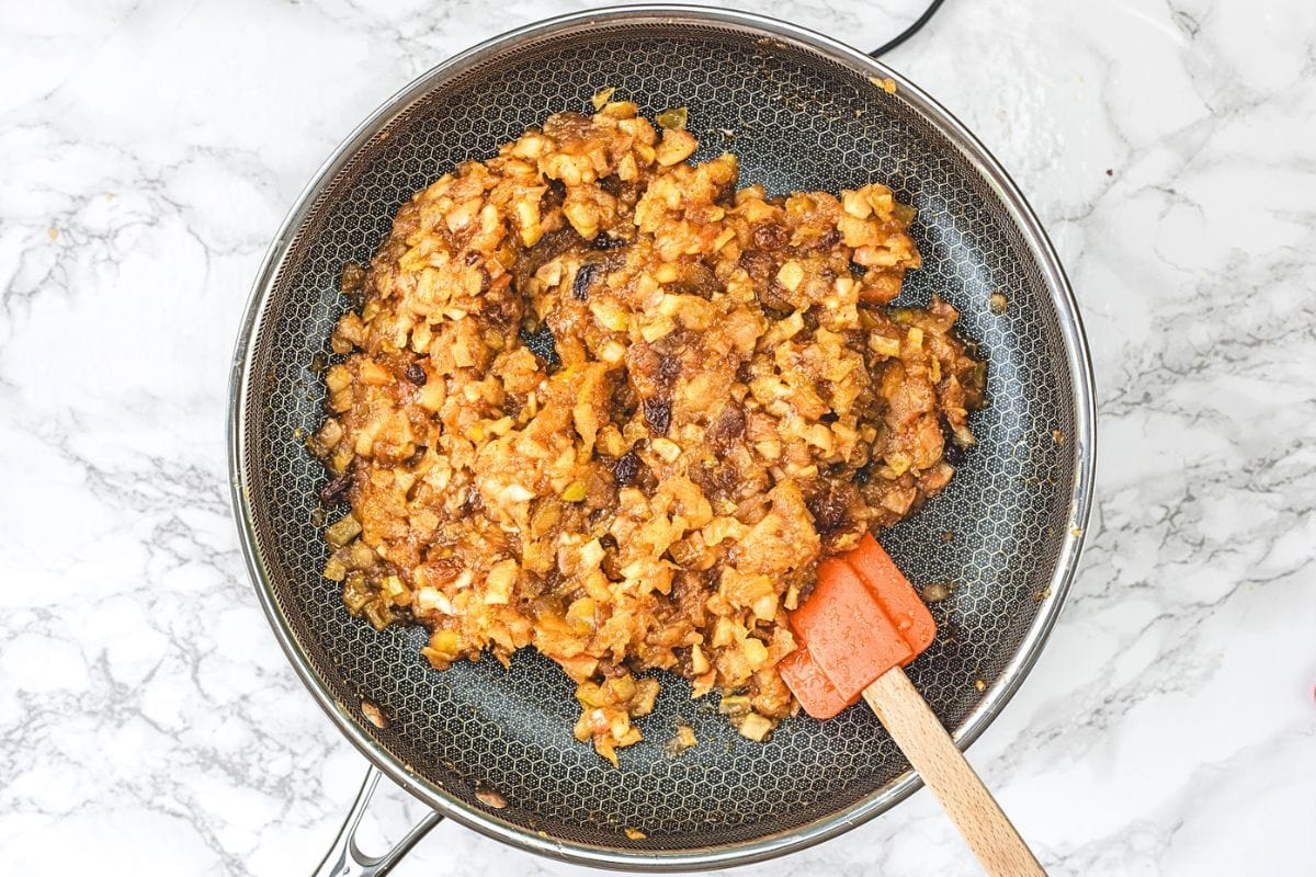 Ready apple chutney in pan with spatula in it.