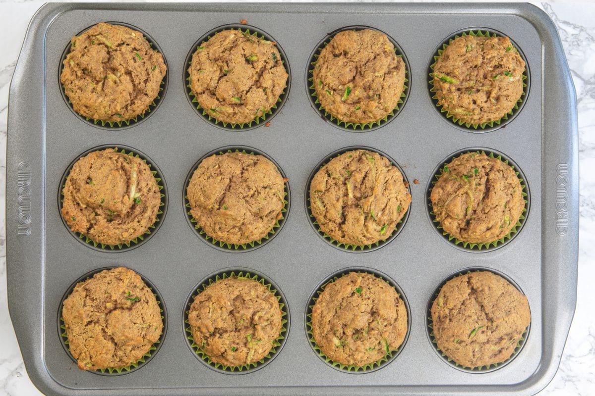 Baked eggless zucchini muffins in a pan.