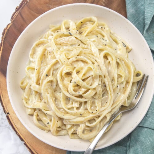 Copycat version of olive garden fettuccine alfredo in a plate with fork.