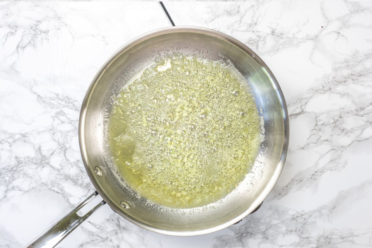 Sauteing garlic in butter for Alfredo sauce.