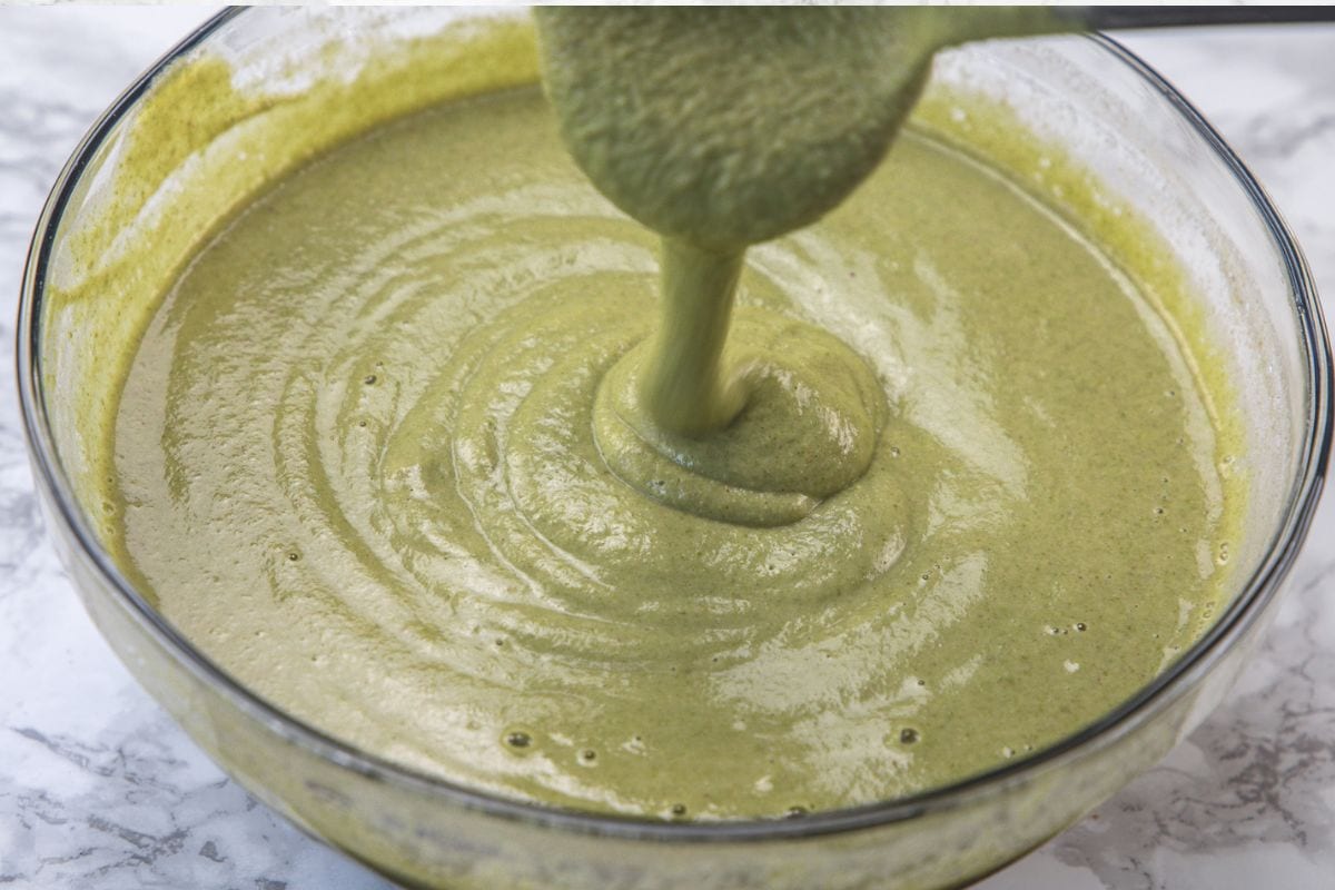 Pouring batter using ladle to show consistency.