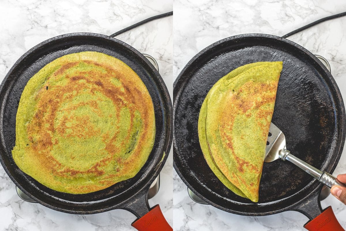 Cooked pesarattu in a pan and folded in half.