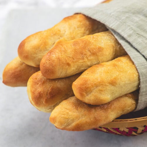 Olive garden breadsticks wrapped in a napkin.
